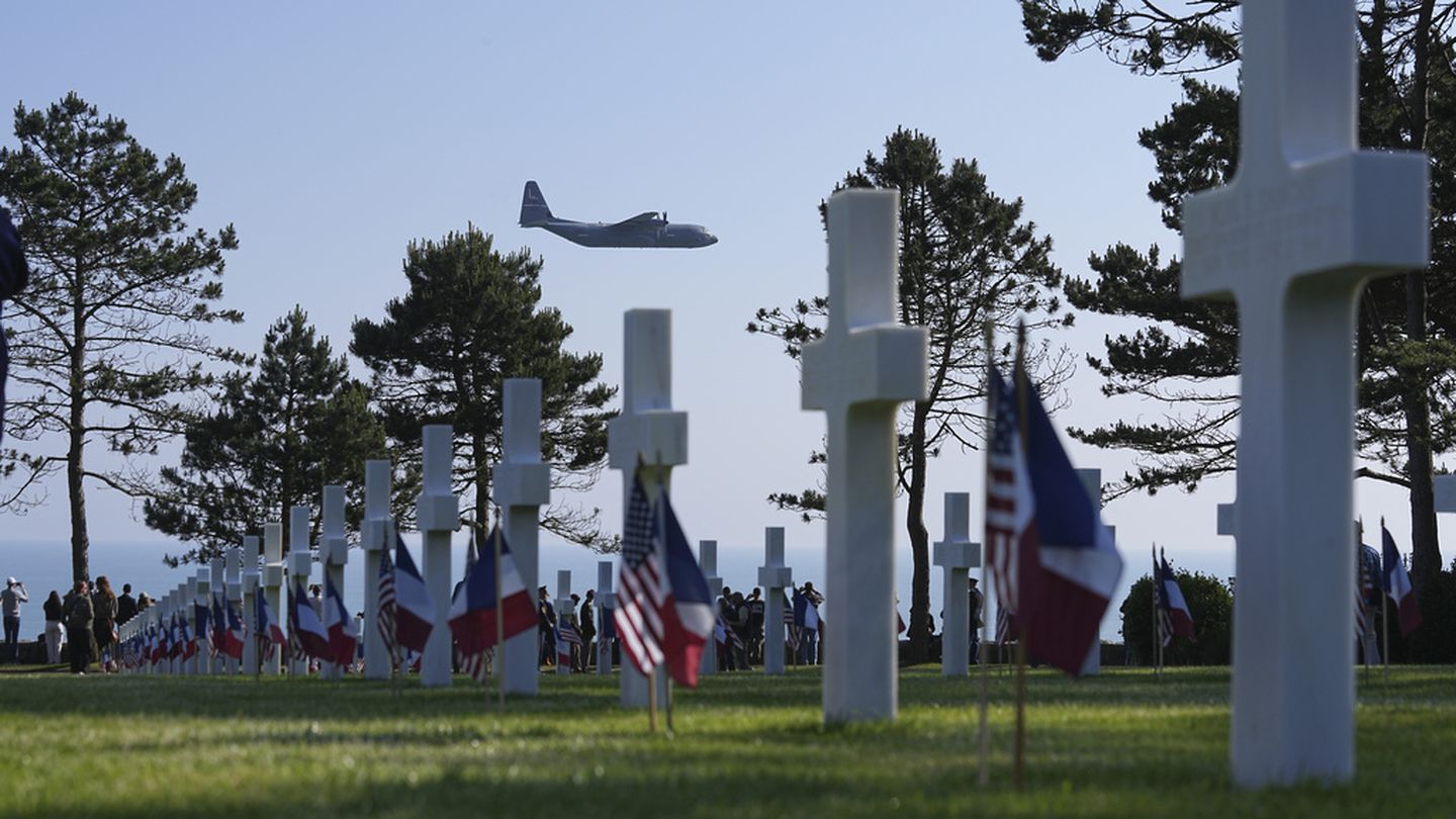 A military plane flies over an US cemetery near Colleville-sur-Mer Normandy, Thursday, June 6, 2024. (Laurent Cipriani/AP)