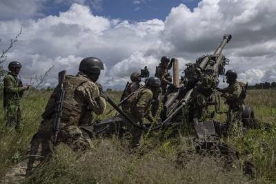 Ukrainian servicemen prepare to fire at Russian positions from a U.S.-supplied M777 howitzer in Kharkiv region, Ukraine, July 14, 2022.